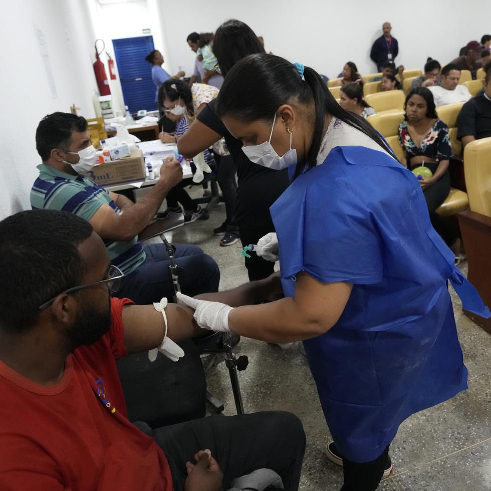 Personas contagiadas con dengue reciben atención en una clínica provisional en el vecindario de Santa María, en Brasilia, Brasil.