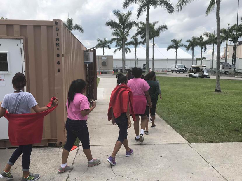 Varios niños inmigrantes mientras caminan dentro del Refugio Temporal de Homestead para niños inmigrantes no acompañados, en Florida.