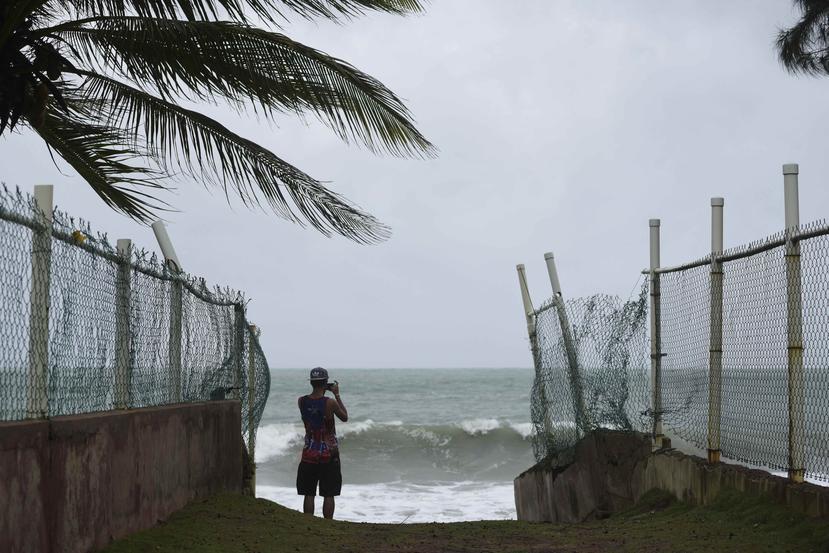 A man photographs the ocean before the arrival of Hurricane Irma, in luquillo, Puerto Rico, AP.