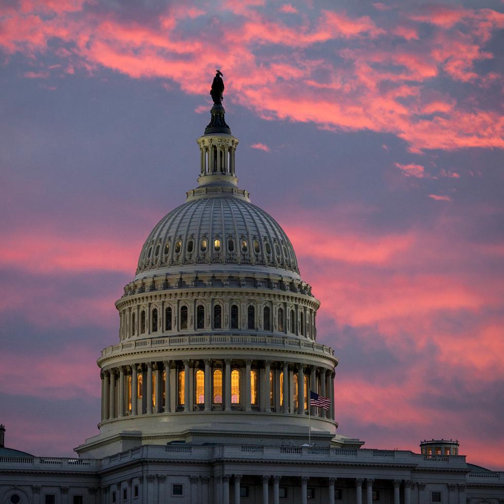 FILE - In this Thursday, Nov. 30, 2017, file photo, the sky over The Capitol is lit up at dawn as Senate Republicans work to pass their sweeping tax bill this week in Washington, (AP Photo/J. Scott Applewhite)