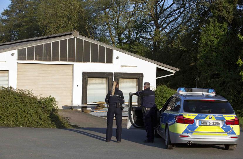 Dos agentes de policía de pie ante un almacén donde se encontraron sustancias peligrosas en la localidad de Preussisch Oldendorf, cerca de la ciudad de Bielefeld, Alemania. (Oliver Krato/dpa via AP)