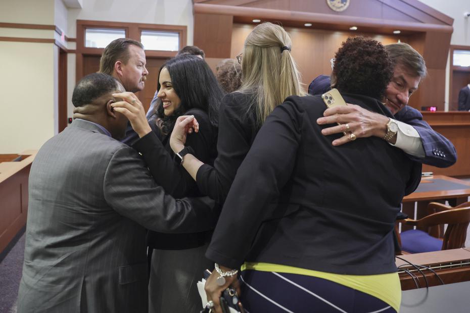 Members of Johnny Depp's legal team embrace after the verdict is read, in which he vindicates his position that Heard fabricated claims that Depp abused her before and during their brief marriage.