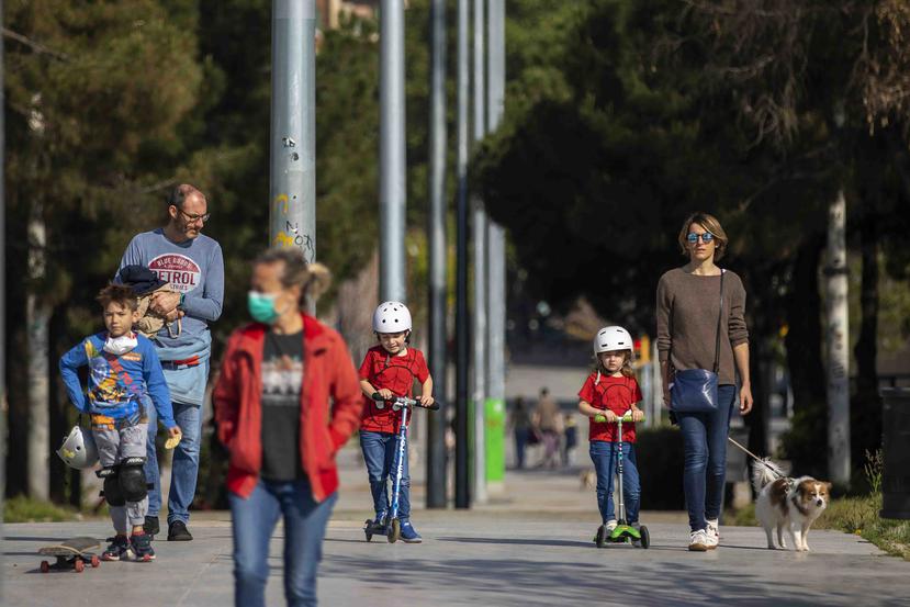 Familias caminan por un bulevar en Barcelona, España. (AP)
