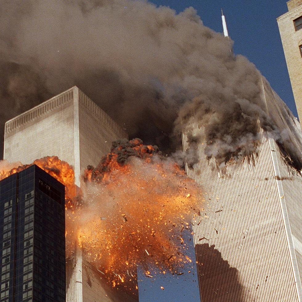 RETRANSMITTED TO PROVIDE ALTERNATE CROP -- Smoke billows from one of the towers of the World Trade Center and flames and debris explode from the second tower, Tuesday, Sept. 11, 2001. In one of the most horrifying attacks ever against the United States, terrorists crashed two airliners into the World Trade Center in a deadly series of blows that brought down the twin 110-story towers. (AP Photo/Chao Soi Cheong)