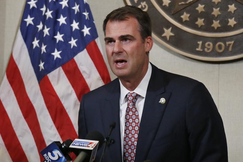 FILE - In this July 9, 2020, file photo Oklahoma Gov. Kevin Stitt speaks during a news conference in Oklahoma City. Stitt announced Wednesday, July 15, 2020, that he's tested positive for the coronavirus and that he is isolating at home. The first-term Republican governor has backed one of the country's most aggressive reopening plans, has resisted any statewide mandate on masks and rarely wears one himself. (AP Photo/Sue Ogrocki, File)