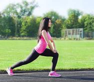 woman sport on stadium leg stretching exercises
