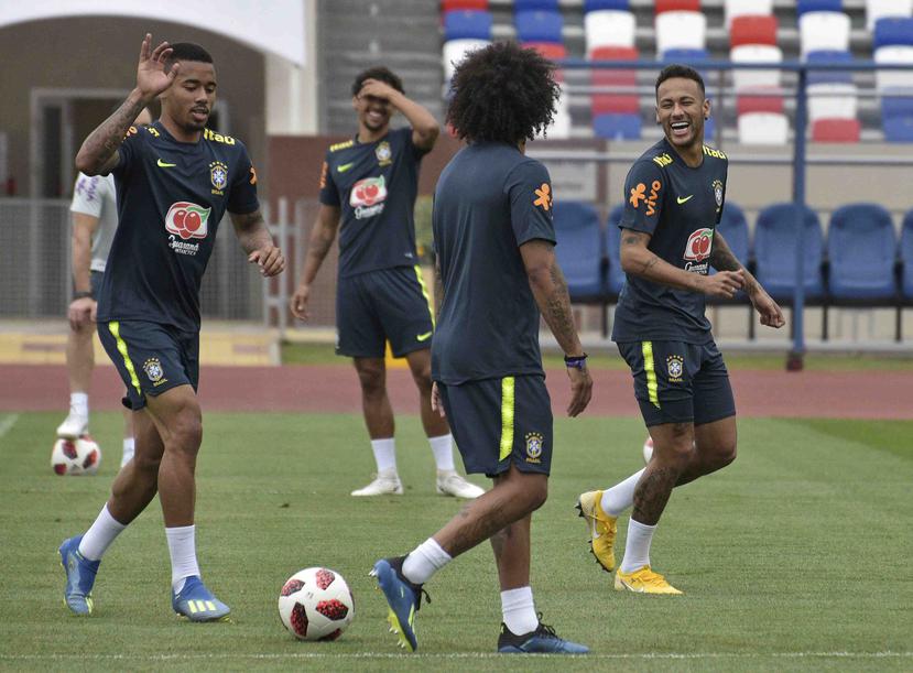 Neymar (derecha) y sus compañeros sonríen durante la práctica de Brasil. (AP)