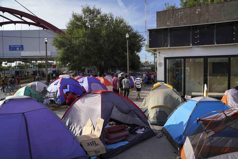 Fotografía del 30 de agosto de 2019 de personas en busca de asilo atravesando un campamento cerca del puente internacional Gateway en Matamoros, México. (AP / Veronica G. Cárdenas)
