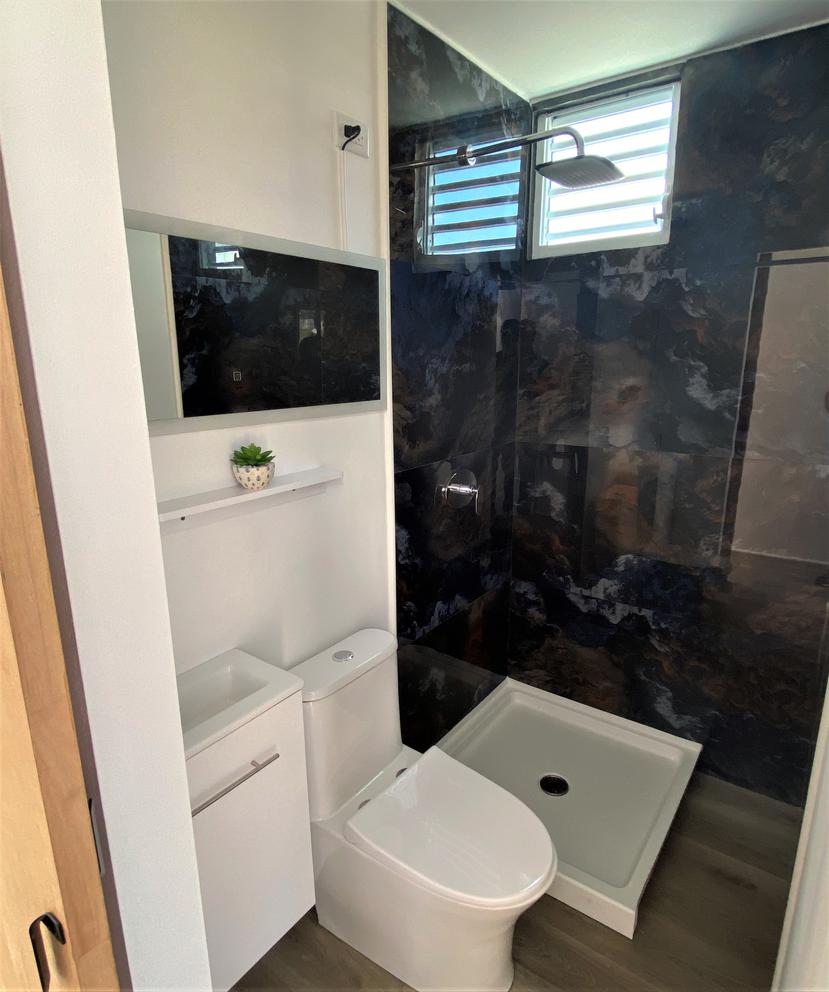 The bathroom equipment, which is accessed with a sliding door, is included.