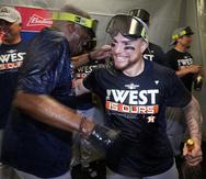 El receptor boricua Christian Vázquez celebra el título divisional con el veterano dirigente de los Astros, Dusty Baker.
