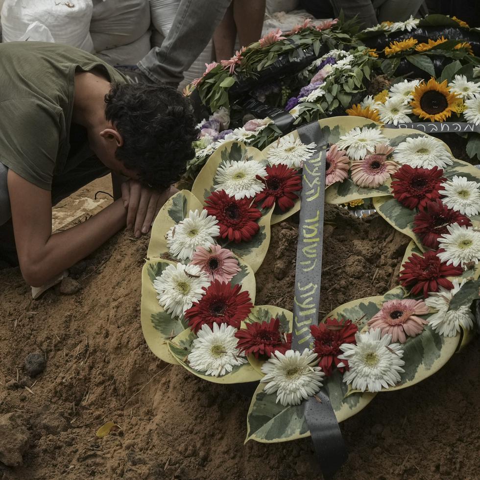 A man mourns during the funeral of Israeli Col. Roi Levy at the Mount Herzl cemetery in Jerusalem on Monday, Oct. 9, 2023. Col. Roi Levy was killed after Hamas militants stormed from the blockaded Gaza Strip into nearby Israeli towns. Israel's vaunted military and intelligence apparatus was caught completely off guard, bringing heavy battles to its streets for the first time in decades. (AP Photo/Maya Alleruzzo)