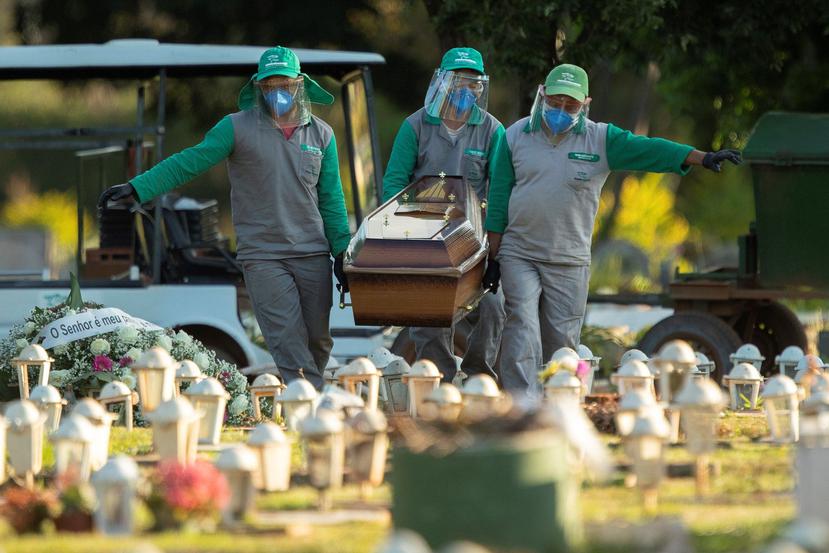 Trabajadores del cementerio Campo de Esperanza entierran a una víctima de COVID-19, en Brasil. (EFE)