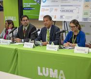 Wayne Stensby, CEO of LUMA Energy (center).
