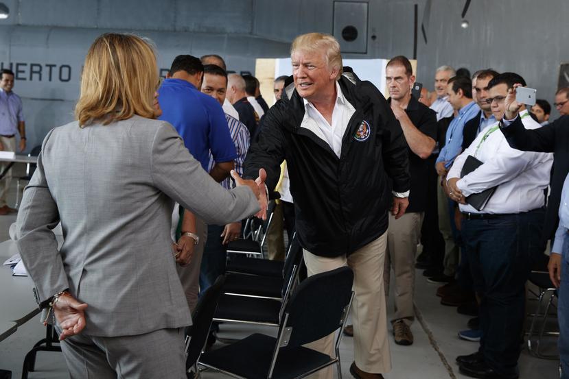 President Donald Trump shakes hands with San Juan Mayor Carmen Yulin Cruz during a briefing on hurricane recovery efforts with first responders at Luis Muniz Air National Guard Base, Tuesday, Oct. 3, 2017, in San Juan, Puerto Rico. (AP)