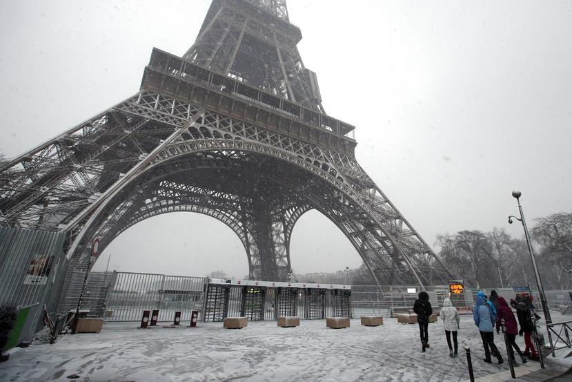 Una imagen poco habitual de la Torre Eiffel en París, Francia, donde se le ve rodeada de nieve (AP/Francois Mori).