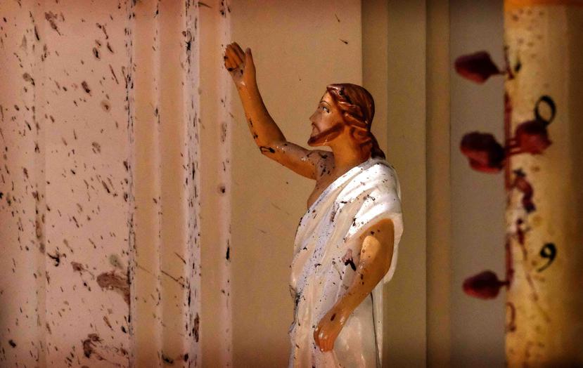 Una imagen de Jesucristo quedó manchada de sangre tras el atentado en la iglesia San Sebastián. (AP)
