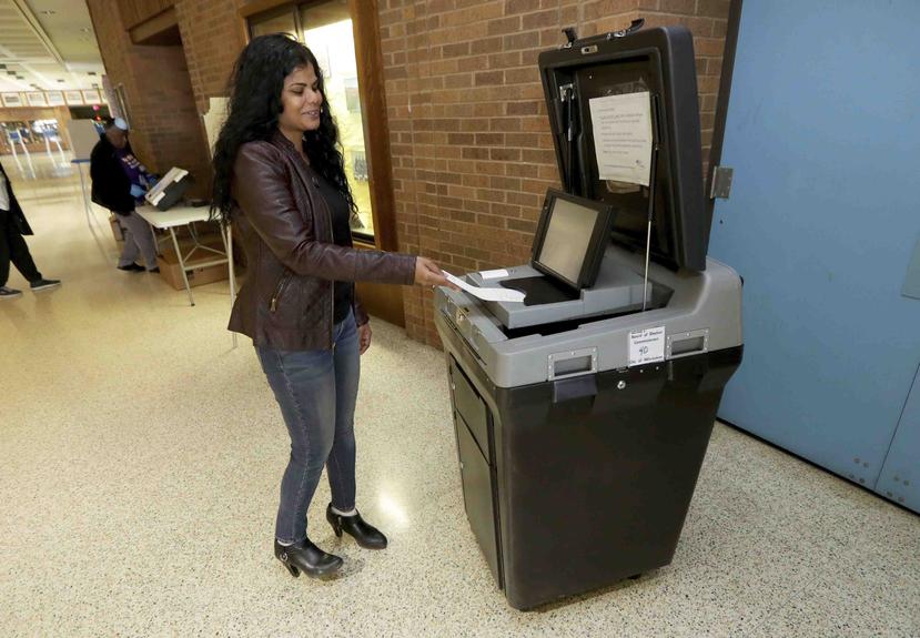 Molly King, una trabajadora electoral, prueba una máquina de votaciones en la Escuela Secundaria South Division en Milwaukee. (AP)