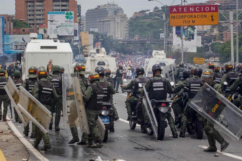 Miles de opositores se movilizaron hacia la principal autopista de la capital, donde la guardia nacional volvió a encararlos con gases. (Agencia EFE)