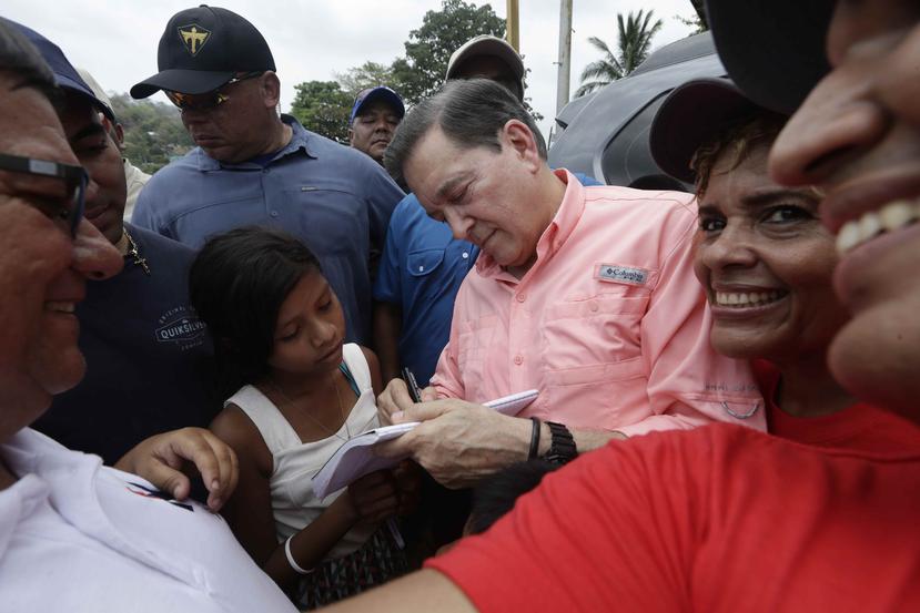 El candidato presidencial Laurentino Cortizo firma autógrafos a su salida de una reunión. (AP / Arnulfo Franco)
