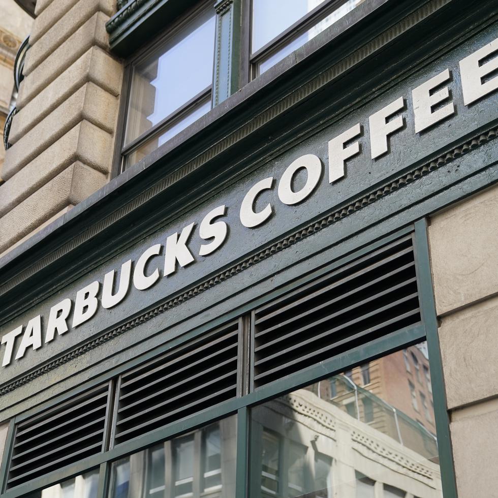 ARCHIVO - Un letrero de Starbucks sobre una tienda de Manhattan, Nueva York, el martes 13 de junio de 2023. (AP Foto/John Minchillo, Archivo)