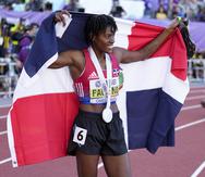 La dominicana Marileidy Paulino festeja con su bandera tras conseguir la medalla de plata en los 400 metros, durante el Mundial de Atletismo en Eugene, Oregón.