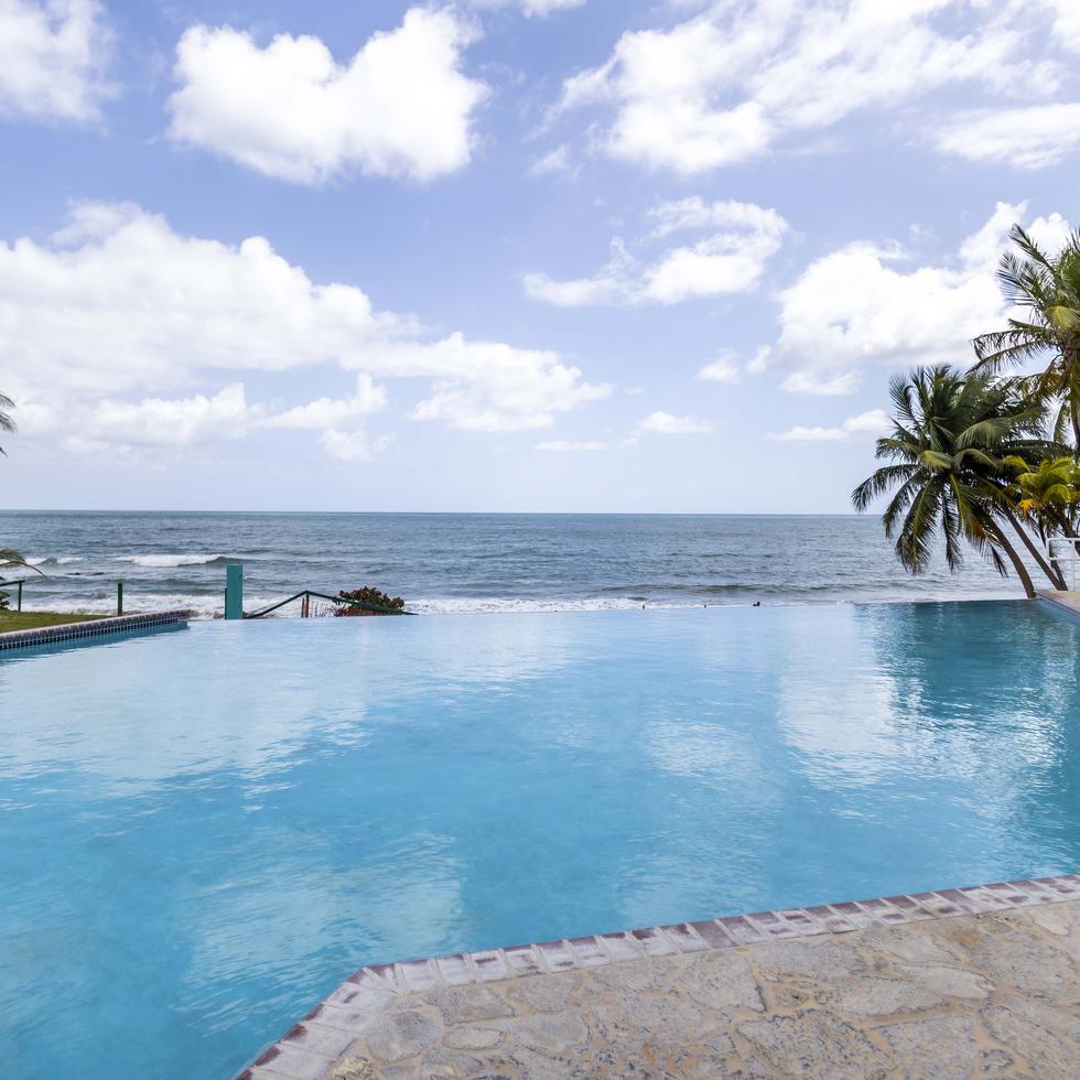 Infinity pool that visually extends into the Caribbean Sea.