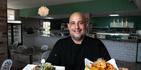 El chef y propietario Eric Pellot Dumeng muestra dos de los platos que se sirven en el establecimiento de comida.