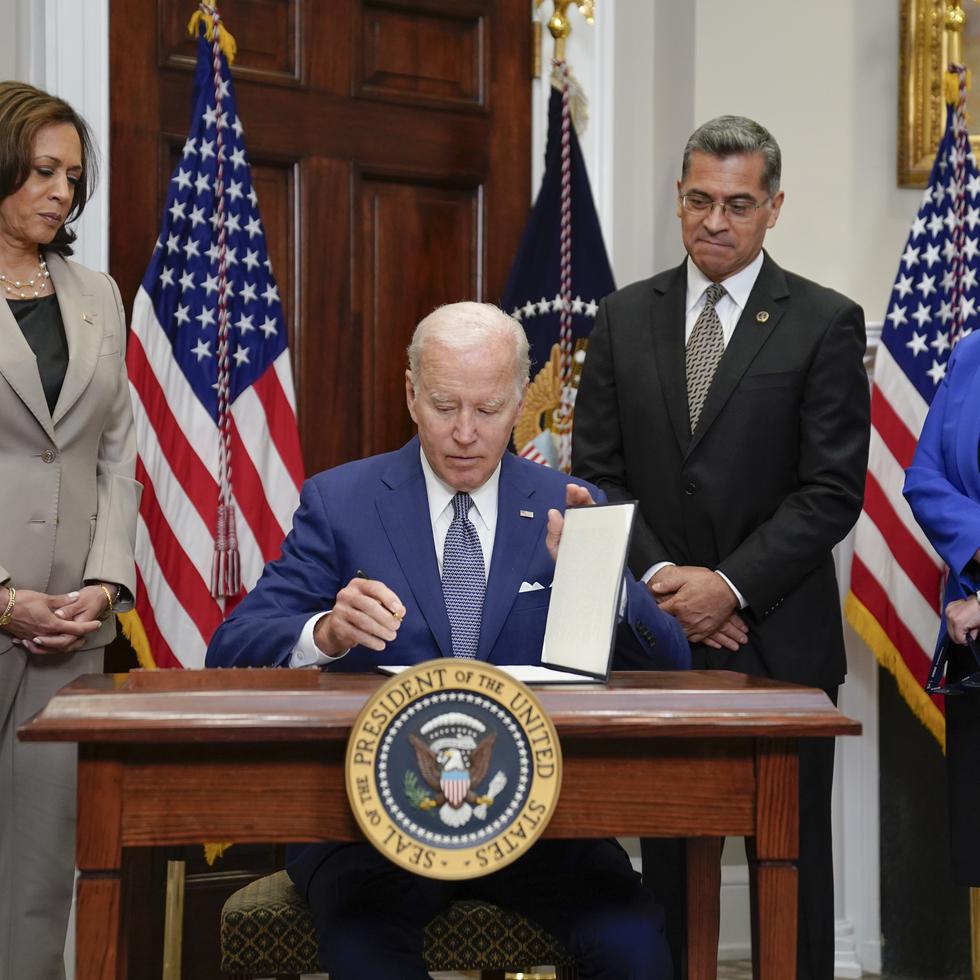 President Joe Biden signs an executive order on abortion access during an event in the Roosevelt Room of the White House, Friday, July 8, 2022, in Washington. From left, Vice President Kamala Harris, Health and Human Services Secretary Xavier Becerra, and Deputy Attorney General Lisa Monaco look on. (AP Photo/Evan Vucci)