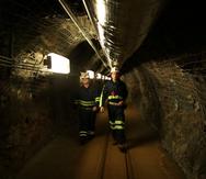 Dos científicos caminan por un túnel de una vieja mina de oro, a una milla de profundidad, en Lead, Dakota del Sur, donde funciona un centro de investigaciones que trata de encontrar materia oscura en las profunidades de la Tierra.