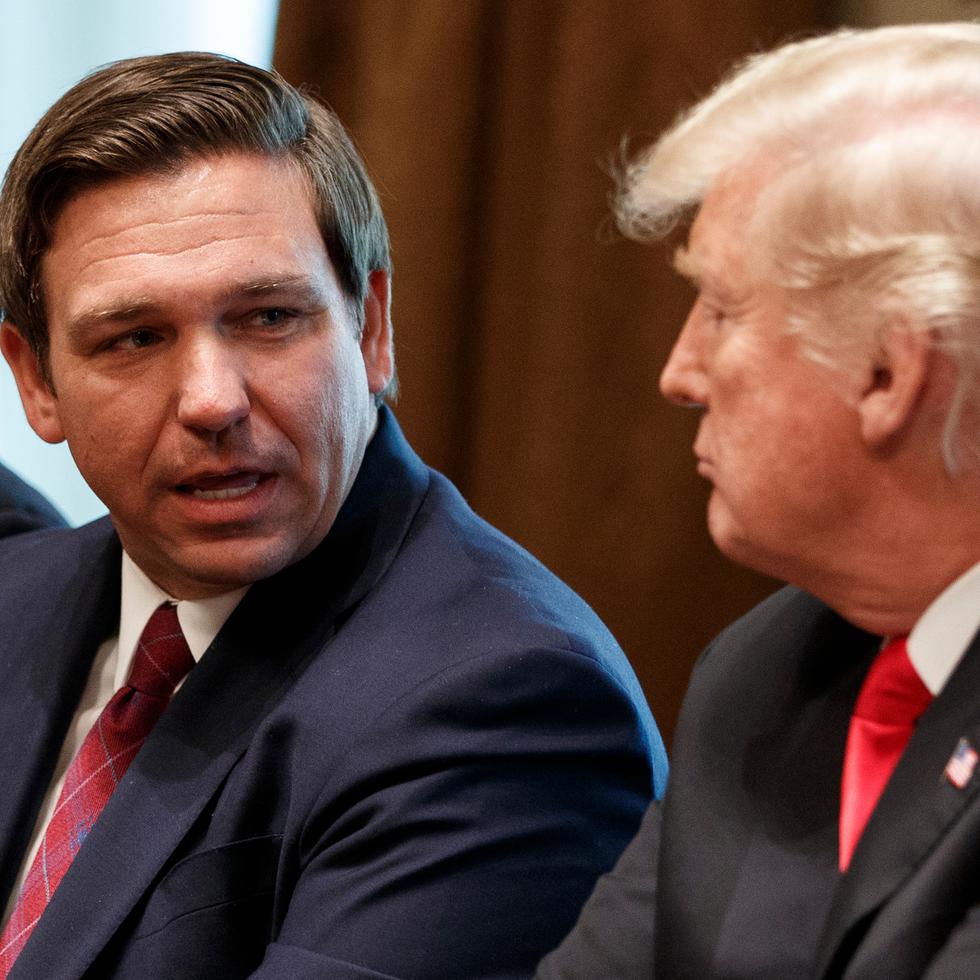FILE - Governor-elect Ron DeSantis, R-Fla., talks with President Donald Trump during a meeting with newly elected governors in the Cabinet Room of the White House, Dec. 13, 2018, in Washington. From left, Governor-elect J.B. Pritzker, D-Ill., DeSantis, and Trump. (AP Photo/Evan Vucci, File)