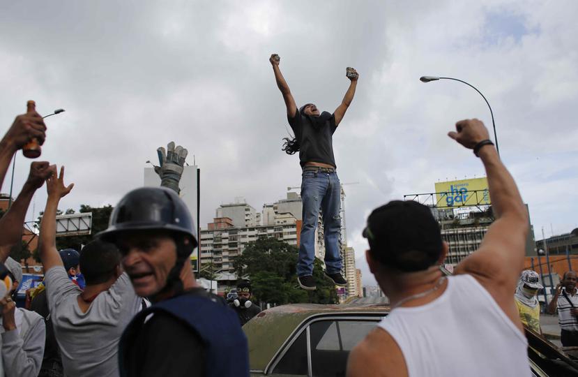 Manifestantes opositores enfrentan a las fuerzas de seguridad durante una marcha hacia la Corte Suprema en Caracas, Venezuela. (AP)