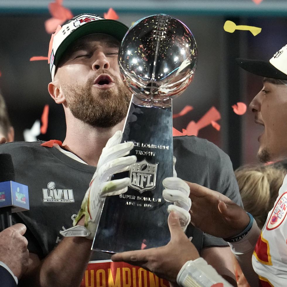 El tight end de los Chiefs de Kansas City Travis Kelce (izquierda), y el quarterback Patrick Mahomes (15) sostienen el trofeo Vince Lombardi luego de ganar el Super Bowl 57 ante los Eagles de Filadelfia el domingo 12 de febrero de 2023.
