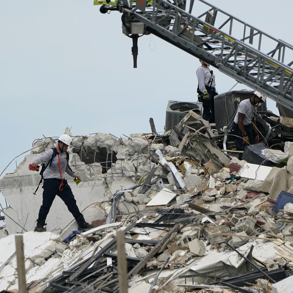 Rescue worker walk among the rubble where a wing of a 12-story beachfront condo building collapsed, Thursday, June 24, 2021, in the Surfside area of Miami. (AP Photo/Lynne Sladky)