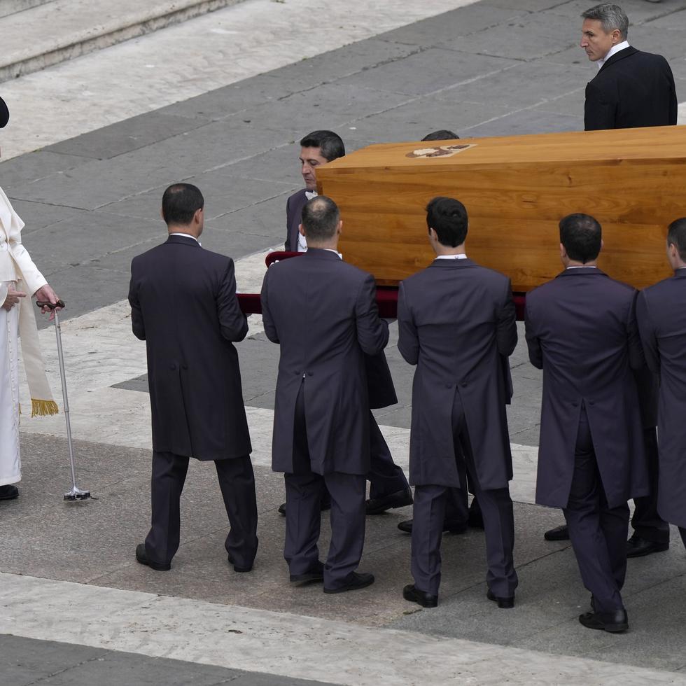 Pope Francis stands in front of the coffin of late Pope Emeritus Benedict XVI being carried away after a funeral mass in St. Peter's Square at the Vatican, Thursday, Jan. 5, 2023. Benedict died at 95 on Dec. 31 in the monastery on the Vatican grounds where he had spent nearly all of his decade in retirement. (AP Photo/Ben Curtis)