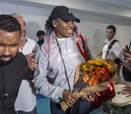 Venus Williams sostiene un ramo de flores tras su llegada al Aeropuerto Internacional Luis Muñoz Marín en Carolina.