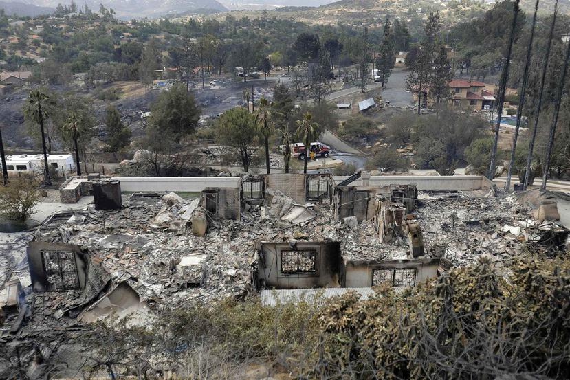 El incendio causó la muerte de una mujer en su vivienda y destruyó 72 estructuras incluyendo viviendas. (AP)