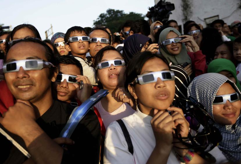 Para poder ver el eclipse de manera segura, se deben usar lentes especializados que poseen un filtro que bloquea los rayos dañinos del Sol. (Archivo AP)
