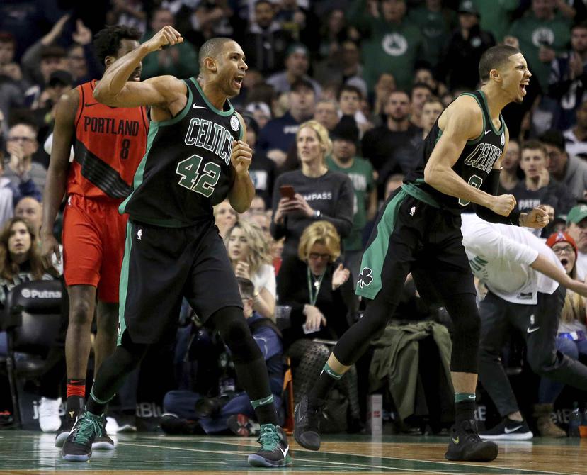 Los jugadores de los Celtics de Boston Al Horford (42) y Jayson Tatum (0) celebran luego que una decisión arbitral fue a su favor a finales de un partido de la NBA contra los Trail Blazers de Portland. (AP)