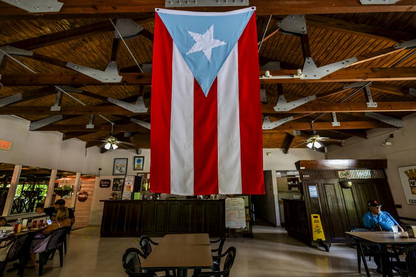 A large Puerto Rican flag hangs from the ceiling.