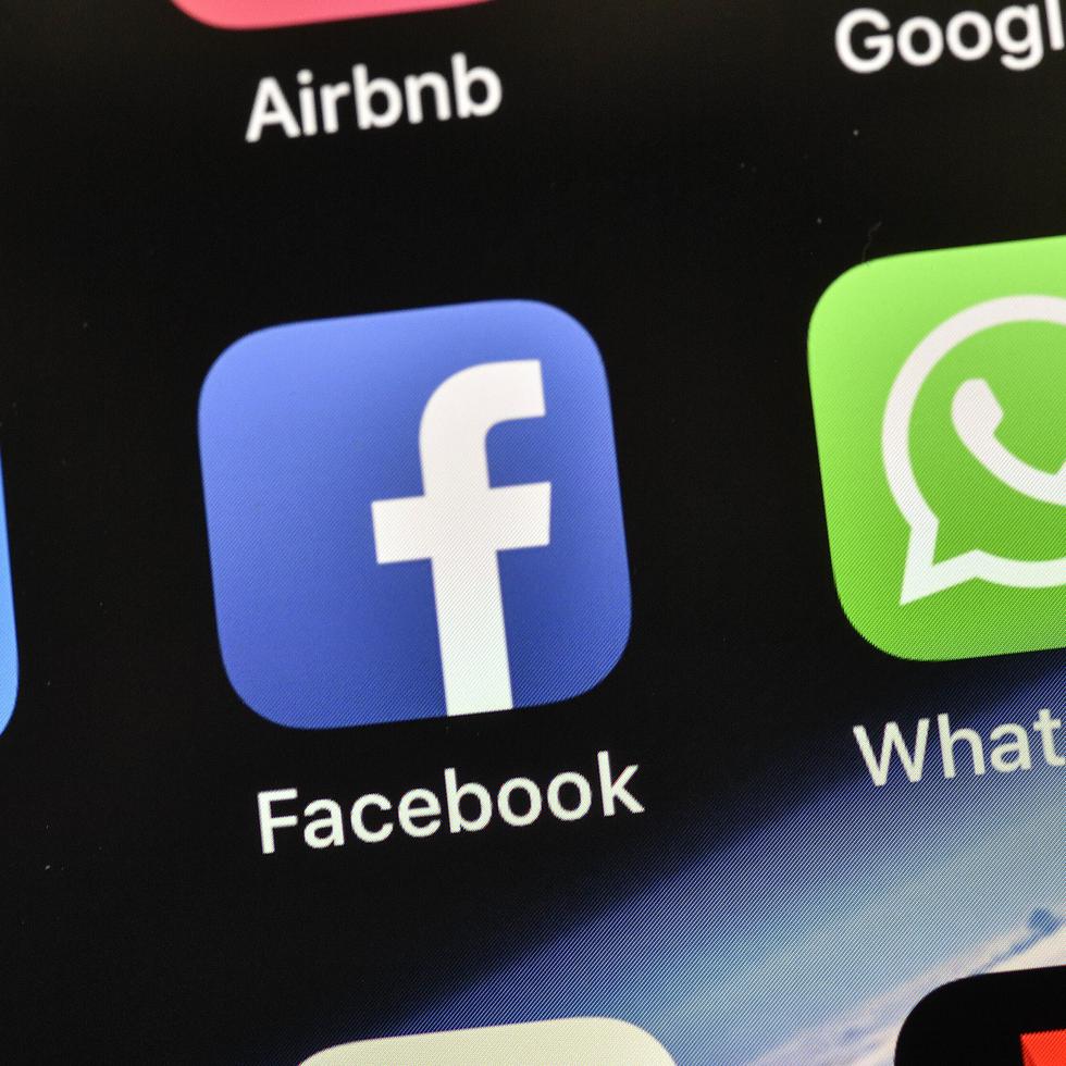 FILE - In this Nov. 15, 2018 file photo, the icons of Facebook and WhatsApp are pictured on an iPhone, in Gelsenkirchen, Germany. Last spring, as false claims about vaccine safety threatened to undermine the world's response to COVID-19, researchers at Facebook wrote that they could reduce vaccine misinformation by tweaking how vaccine posts show up on users' newsfeeds, or by turning off comments entirely. Yet despite internal documents showing these changes worked, Facebook was slow to take action. (AP Photo/Martin Meissner, File)