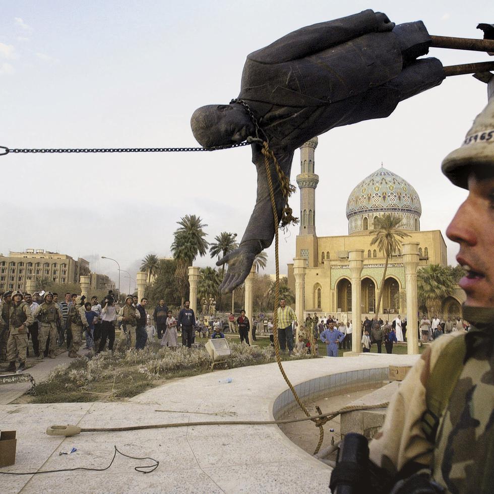ADVANCE FOR PUBLICATION ON FRIDAY, SEPT. 10, AND THEREAFTER - FILE - Iraqi civilians and U.S. soldiers pull down a statue of Saddam Hussein in downtown Baghdad, in this April 9, 2003 file photo. The U.S. invaded Iraq on false claims that Hussein was hiding weapons of mass destruction. (AP Photo/Jerome Delay, File)