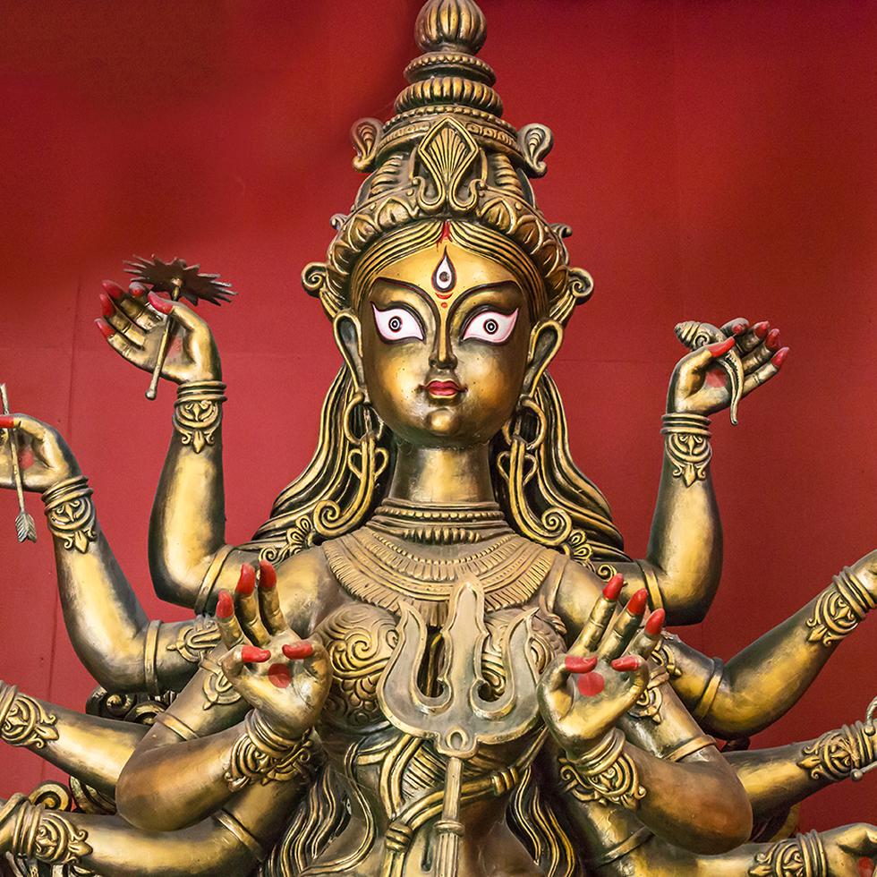Terracotta Durga idol copper finish closeup portrait. Goddess durga is worshipped by Hindus in India and abroad and depicts victory of good over evil.
