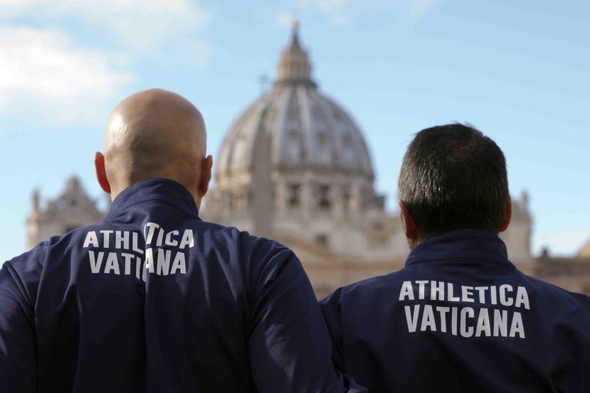 Integrantes del equipo vaticano de atletismo posan para la foto frente a la Basílica de San Pedro. (AP)
