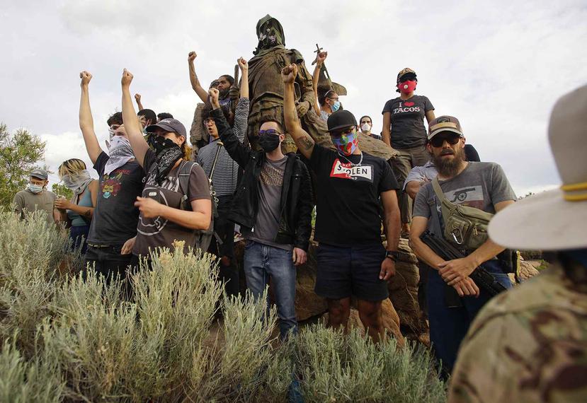 Manifestantes se trepan a la estatua del conquistador español Don Juan de Oñate en Albuquerque, Nuevo México, el 15 de junio del 2020.  (Adolphe Pierre-Louis/The Albuquerque Journal vía AP)
