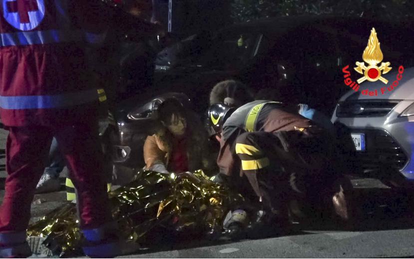 En esta imagen tomada de un video, rescatistas ayudan a heridos en una estampida, en el exterior de un club nocturno en Corinaldo, en el centro de Italia, el 8 de diciembre de 2018. (Vigili del Fuoco via AP)