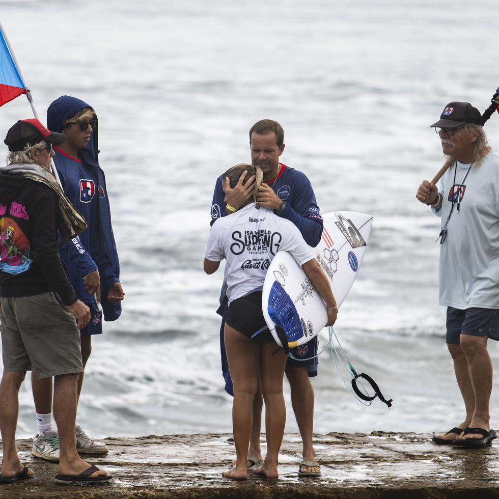 El surfista Brian Toth recibe a Mia Calderón tras su eliminación en repechaje.