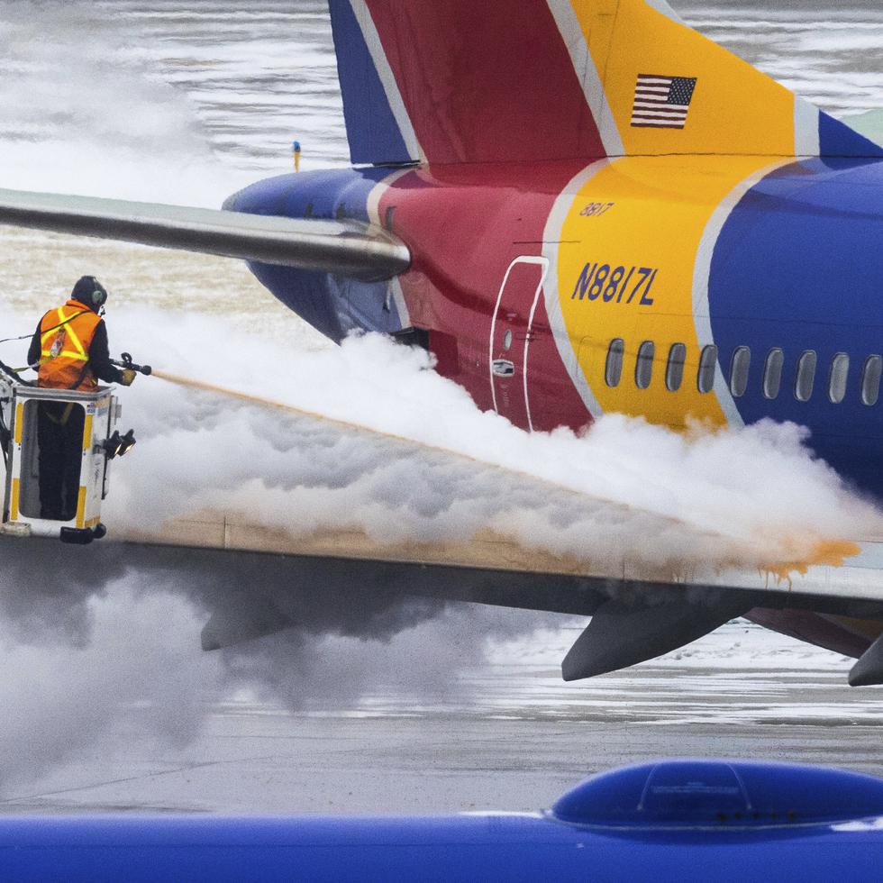 Personal descongela un avión de Southwest Airlines antes del despegue el miércoles 21 de diciembre de 2022 en Omaha, Nebraska. (Chris Machian/Omaha World-Herald vía AP)