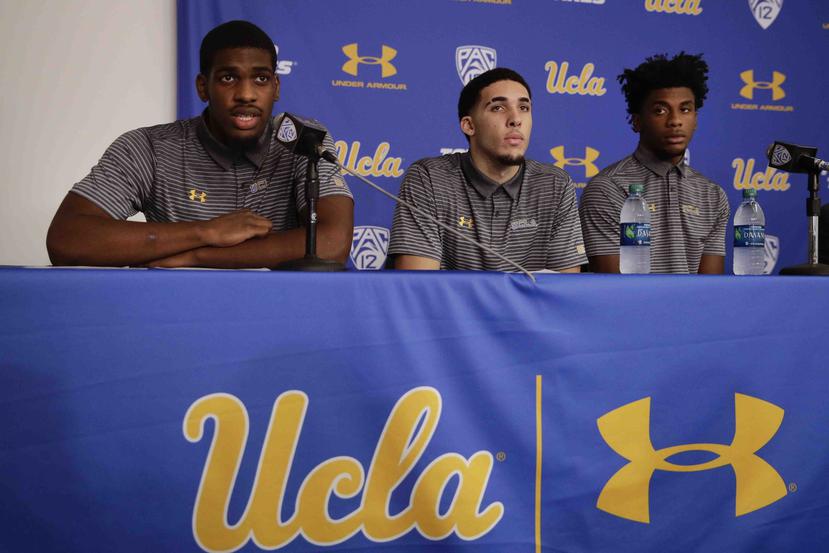 El baloncestista de UCLA Cody Riley, izquierda, lee una declaración , acompañado de sus compañeros de equipo LiAngelo Ball, al centro, y Jalen Hill, en una conferencia de prensa en el campus de la universidad. (AP / Jae C. Hong)