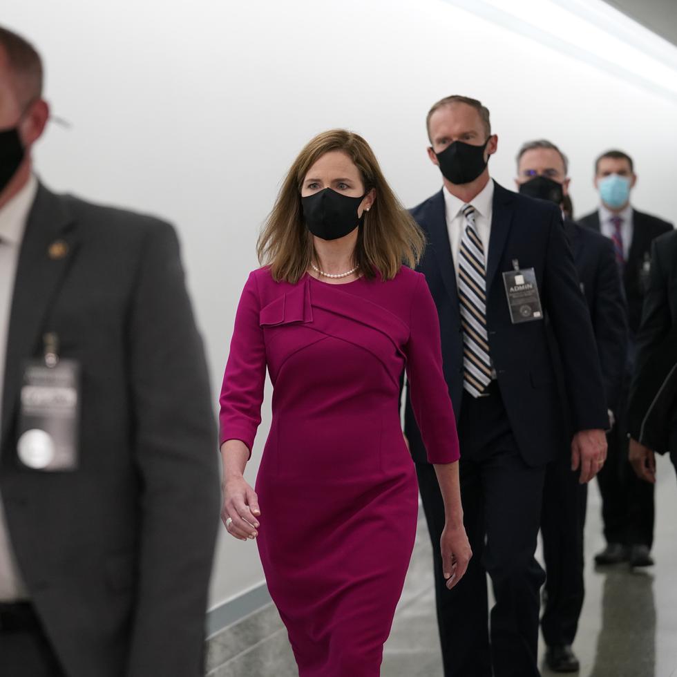 Supreme Court nominee Amy Coney Barrett walks back after a break on Capitol Hill to continue her confirmation hearing before the Senate Judiciary Committee, Monday, Oct. 12, 2020 on Capitol Hill in Washington. (AP Photo/J. Scott Applewhite)