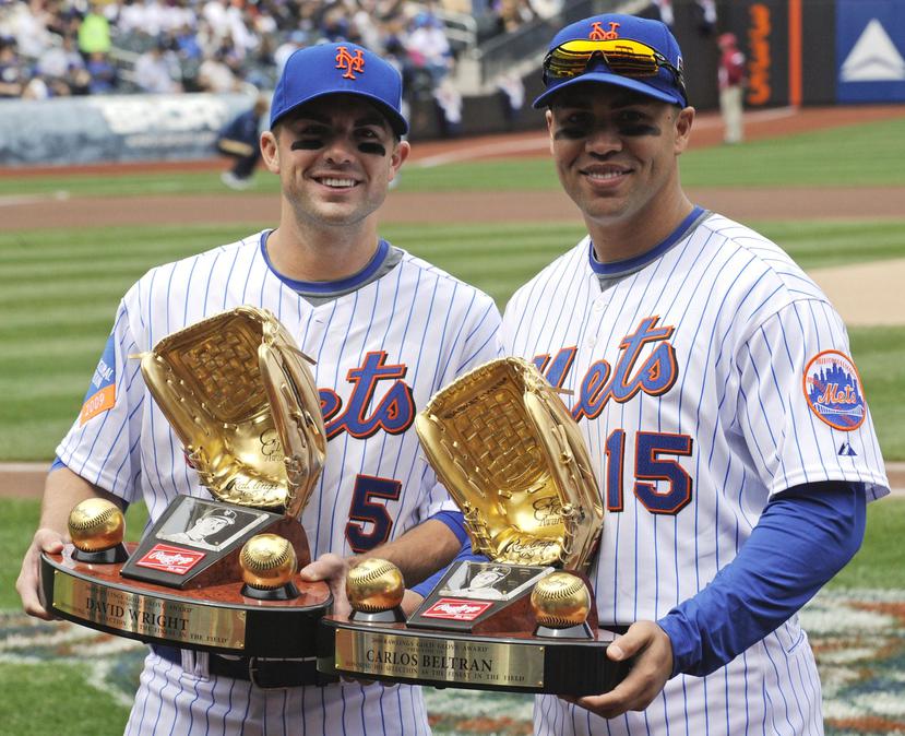Carlos Beltrán, a la derecha, posa con el Guante de Oro que ganó por su gestión defensiva en la temporada 2008 con los Mets de Nueva York. A su lado, el antesalista David Wright. (AP / Bill Kostroun)